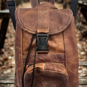 Image 1: Distressed brown leather backpack purse with black buckle closure.